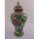 A Chinese famille verte baluster vase and cover decorated with birds, butterflies and foliage