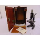 C. Baker a microscope in fitted wooden case, to include additional lenses