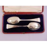 A cased set of silver serving spoons, the back of the bowls embossed with a fox mask and riding