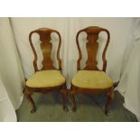 A pair of Georgian walnut open splat back bedroom chairs with padded upholstered seats on four