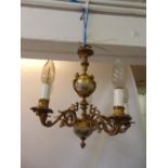 A gilded metal five branch chandelier with painted porcelain panels and cast caryatids