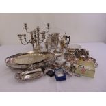 A quantity of silver plate to include candelabra, trays, an ice bucket, beakers and condiments