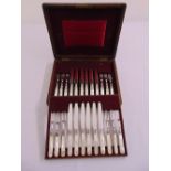 A cased set of twelve Mappin and Webb silver plated mother of pearl handled dessert eaters