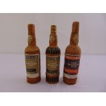 Three bottles of D'Oliveiras Madeira wine in presentation basket