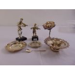 A quantity of silver and white metal to include ashtrays, a candle holder, three figurines and a