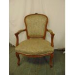 A French style mahogany upholstered armchair on four cabriole legs