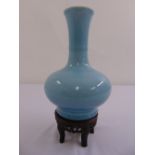 An early 20th century Chinese turquoise ground baluster vase on hardwood stand