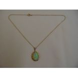 15ct yellow gold pendant set with a fire opal on an integral chain