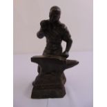 A cast bronze figurine of a blacksmith titled Watsons est 1989, signed JMN