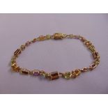 14ct yellow gold garnet, peridot and topaz bracelet, approx total weight 7.5g
