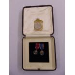 A cased set of miniature medals King George VI and Queen Elizabeth and a 1902 silver medal