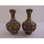 A pair of Cloisonné‚ vases of baluster form decorated with flowers, leaves and scrolls on raised