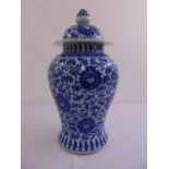 Chinese blue and white baluster vase and cover decorated with flowers, leaves and scrolls
