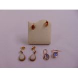 Three pairs of 9ct gold earrings set with various stones, approx total weight 4.9g