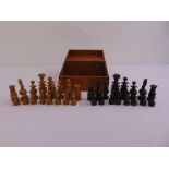 A wooden chess set of customary form in fitted wooden box