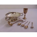 A silver hand hammered bowl with scroll handles on raised circular base, London 1904, a silver sauce