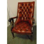 A red leather button back armchair on cabriole legs