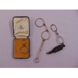 Two pairs of lorgnettes and a magnifying glass in fitted case