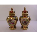 A pair of Vienna baluster vases and covers decorated with ovals depicting classical scenes