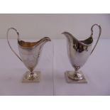 A George III silver cream jug with reeded borders and loop handle, floral and leaf engraved sides on