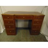 A mahogany rectangular kneehole desk with eight drawers and tooled leather top