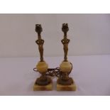 A pair of Ormolu and onyx table lamps on raised square bases