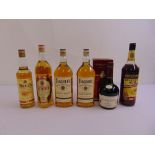 Four bottles of whisky, a bottle of cognac and a bottle of rum (6)