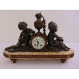 A French 19th century mantle clock, cylindrical flanked by two putti on shaped oval marble stand, to