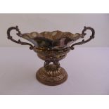 A continental white metal table centre piece of lobed circular form with leaf capped scroll handles,