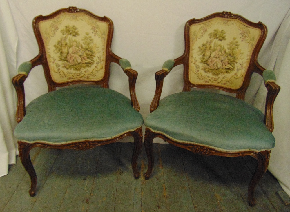 A pair of French style upholstered armchairs on cabriole legs