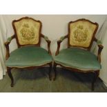 A pair of French style upholstered armchairs on cabriole legs