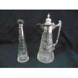 A cut glass decanter with drop stopper and silver collar and a silver plated cut glass claret jug