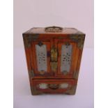 An Oriental rectangular jewellery casket with carved jadeite panels and hinged doors above a