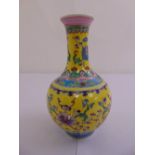 Chinese famille verte baluster vase yellow ground decorated with flowers and vegetation