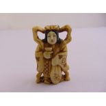 A Japanese Netsuke in the form of a Geisha