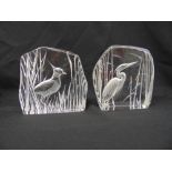 A pair of Matt Jonassen crystal glass paperweights etched with birds in the wild, signed and dated