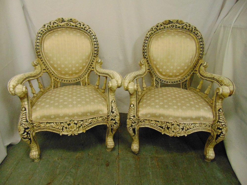 A pair of decorative armchairs inlaid with bone, upholstered seats and backs with scrolling arms