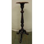 A mahogany plant stand on baluster stem and outswept legs