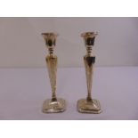 A pair of silver table candlesticks, tapering rectangular on shaped square bases, Chester 1922