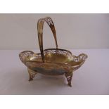 A silver oval fruit basket with pierced swing handle and sides on four pierced bracket feet,