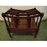 An Edwardian mahogany Canterbury with single drawer on four turned legs with original castors