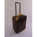 A Louis Vuitton pull-along holdall suitcase with retractable handle and padlock
