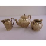 A three piece white metal Indian teaset engraved and chased with figures, elephants and goats