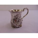A Victorian silver mug, baluster form chased with flowers and leaves, double scroll handle, London
