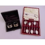 A cased set of silver teaspoons and a cased set of two napkin rings