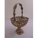 A continental white metal circular fruit basket, scroll pierced sides, chased with flowers,