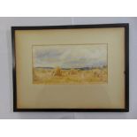 U Alexander framed and glazed watercolour of haystacks, signed bottom right, 15 x 29cm