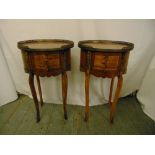 A pair of oval three drawer mahogany side tables on cabriole legs and pierced metal galleries