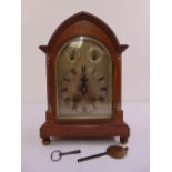 A mahogany cased architectural mantle clock with silvered dial, Roman numerals, to include key and