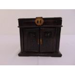 A Chinese rectangular hardwood jewellery casket with hinged cover and doors